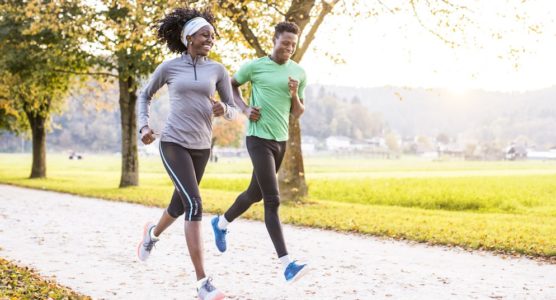Two-people-running-through-a-park-min